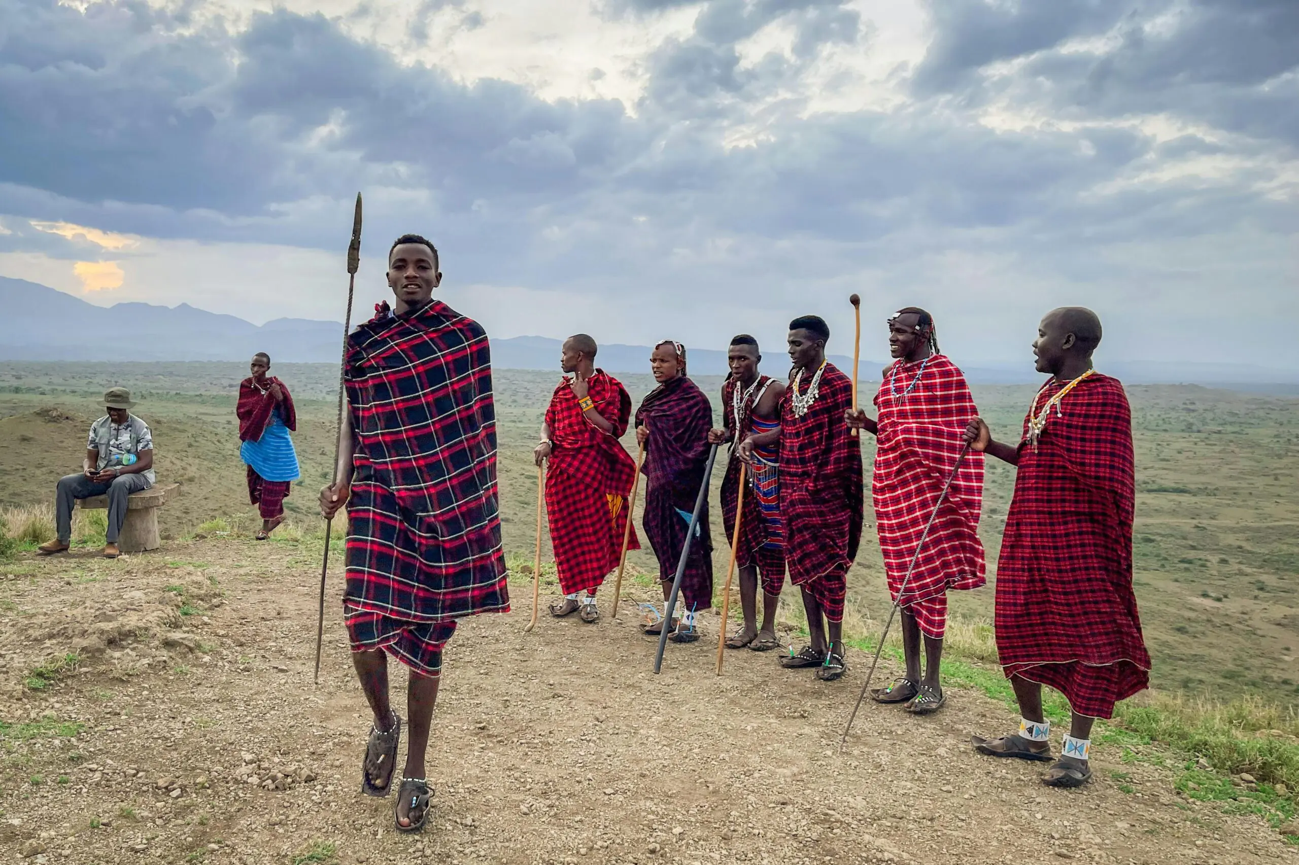A group of Maasai men in colorful traditional garments in the scenic landscapes of Arusha, Tanzania.